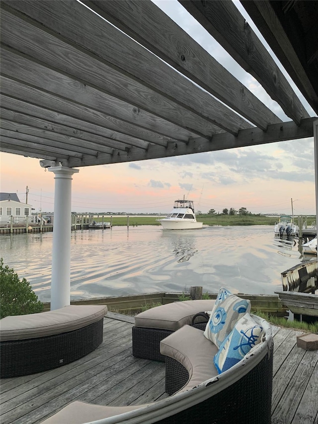 view of dock with a water view and a pergola