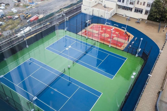 view of tennis court with basketball hoop