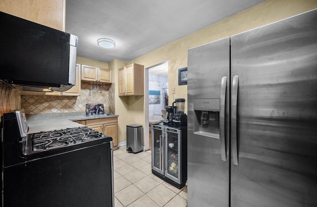 kitchen featuring stainless steel refrigerator with ice dispenser, black range with gas stovetop, light brown cabinetry, and tasteful backsplash