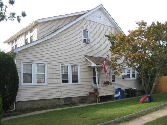 rear view of house with a yard