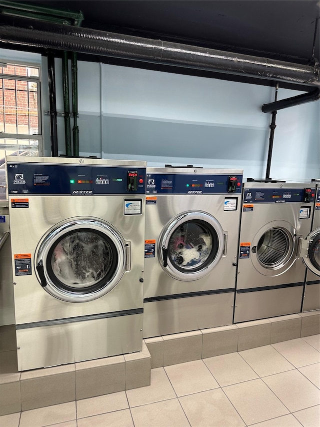 laundry room with tile patterned flooring and washer and clothes dryer