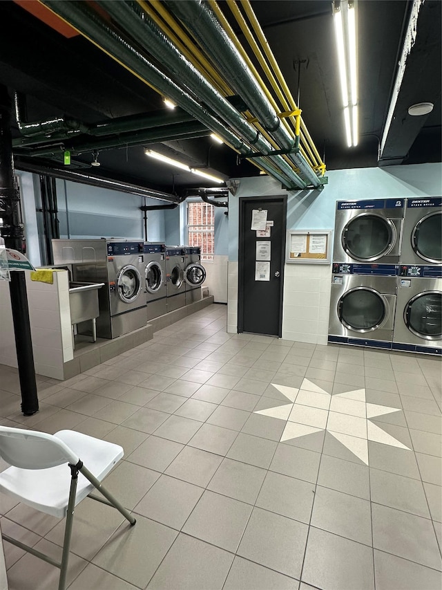 washroom with stacked washer / drying machine, sink, tile patterned flooring, and washer and dryer