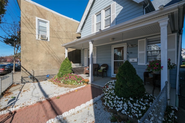 view of exterior entry featuring a porch