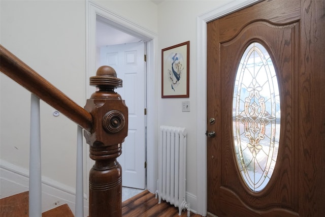 foyer featuring hardwood / wood-style flooring and radiator heating unit