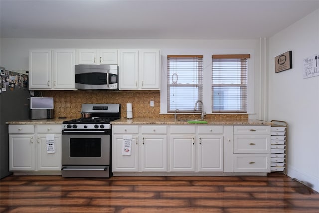 kitchen featuring white cabinetry, sink, dark hardwood / wood-style floors, and appliances with stainless steel finishes