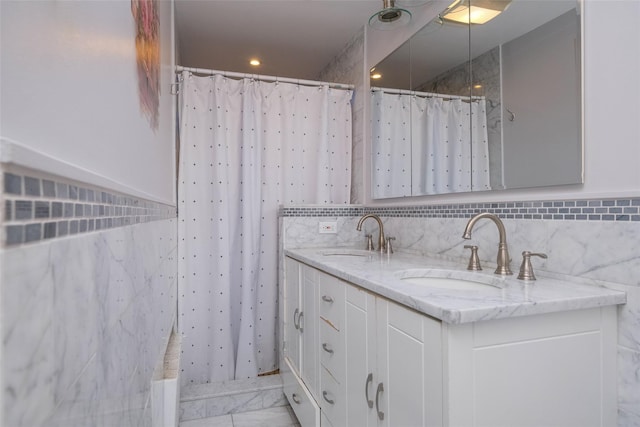 bathroom with vanity and tile walls