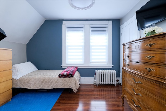 bedroom featuring lofted ceiling, dark wood-type flooring, and radiator heating unit