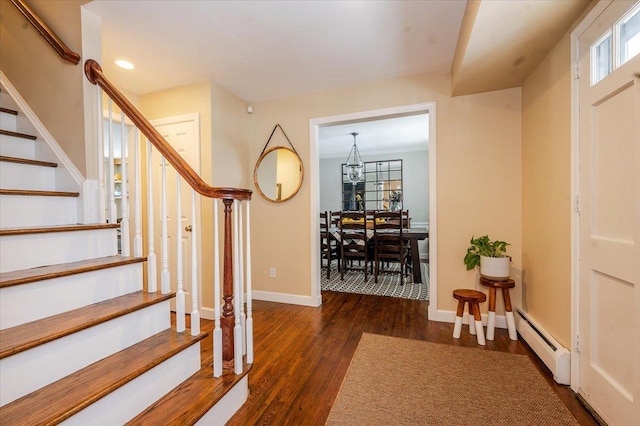 foyer with a baseboard radiator and dark wood-type flooring