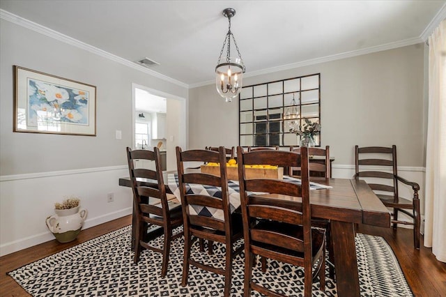 dining space with crown molding and dark hardwood / wood-style floors