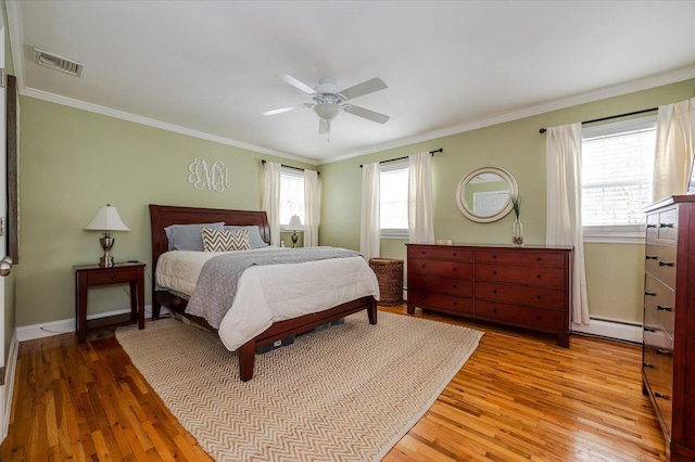 bedroom featuring crown molding, ceiling fan, and light wood-type flooring