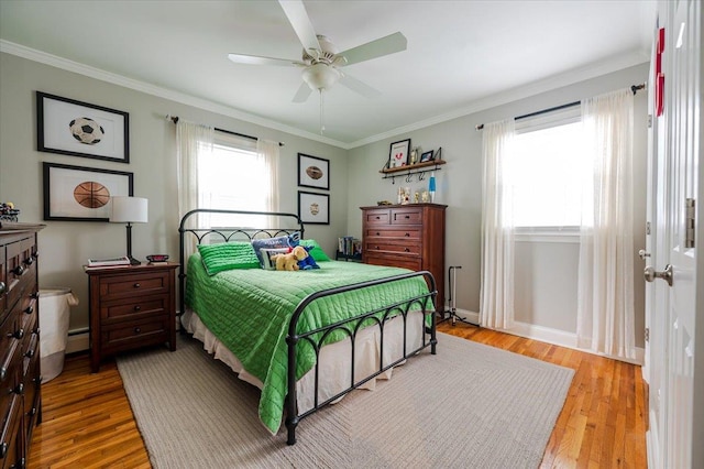 bedroom featuring multiple windows, light hardwood / wood-style flooring, ornamental molding, and ceiling fan