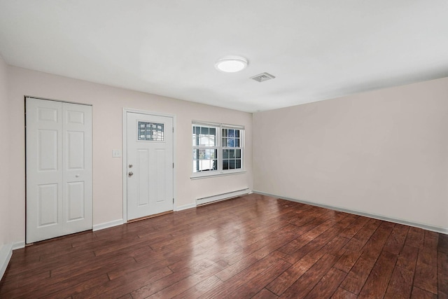 foyer with a baseboard radiator and dark hardwood / wood-style floors