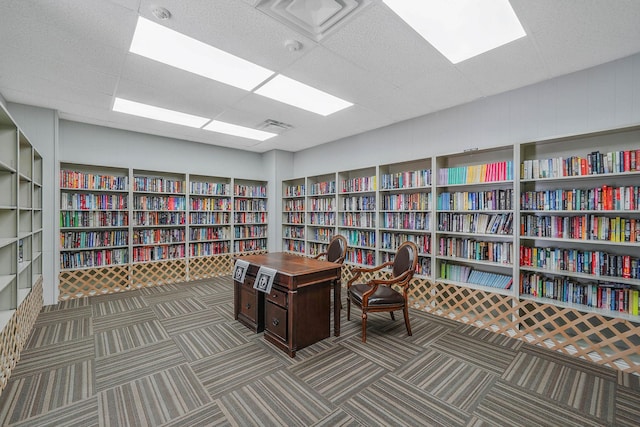 carpeted office space featuring a drop ceiling