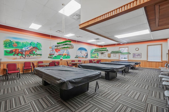 game room featuring a drop ceiling, wood walls, and billiards