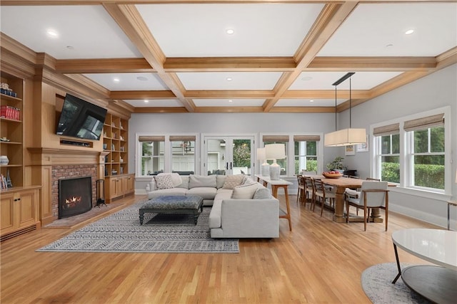 living room featuring a fireplace, beamed ceiling, light hardwood / wood-style flooring, coffered ceiling, and built in shelves