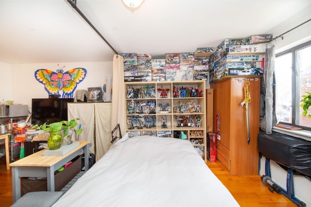 bedroom with hardwood / wood-style floors