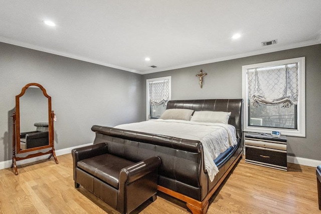 bedroom featuring ornamental molding and light wood-type flooring