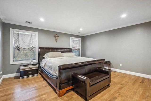 bedroom with crown molding and light wood-type flooring