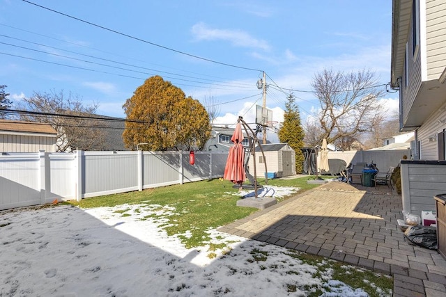 view of yard with a shed and a patio area