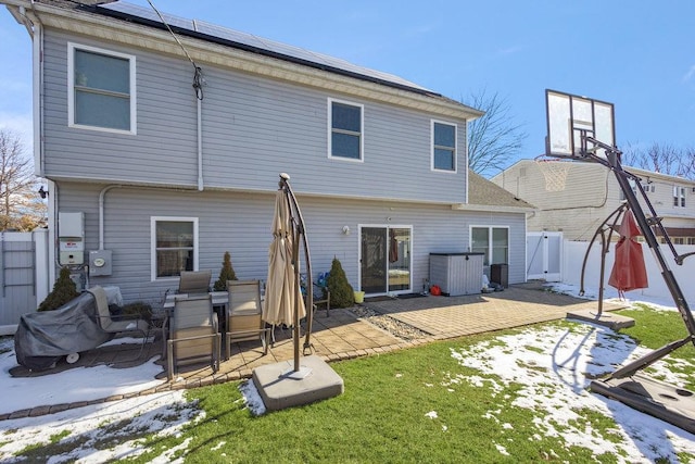 back of house with a patio and a lawn