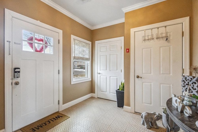 foyer entrance featuring ornamental molding and baseboards