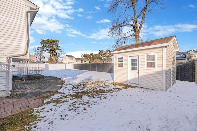 yard covered in snow featuring a storage unit