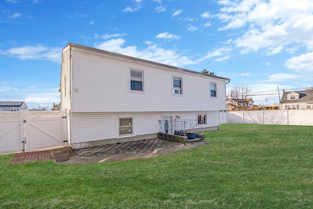 rear view of house featuring a yard