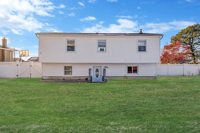 rear view of property with a lawn