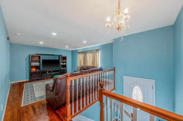 living room with a notable chandelier and dark wood-type flooring