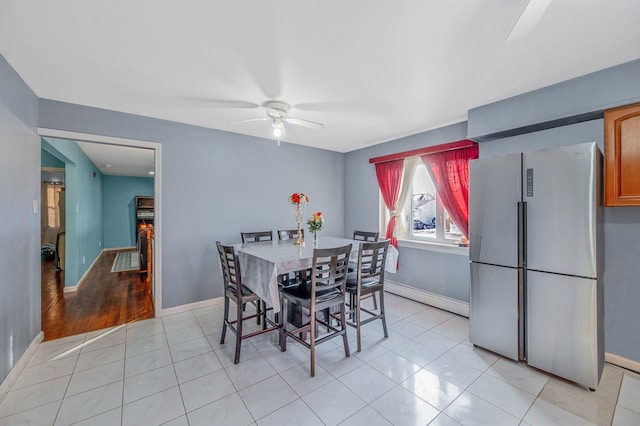 tiled dining space with ceiling fan