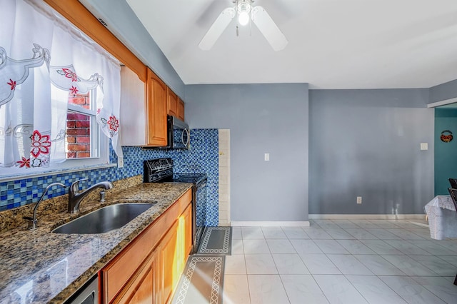 kitchen with light tile patterned flooring, sink, dark stone countertops, black range with electric stovetop, and decorative backsplash