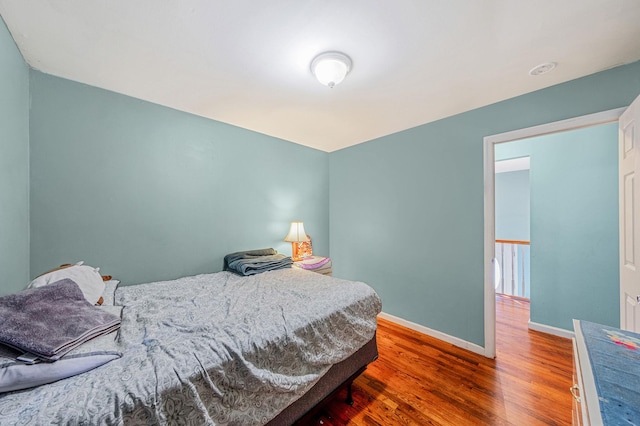 bedroom with dark hardwood / wood-style floors