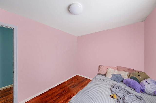 bedroom with dark wood-type flooring