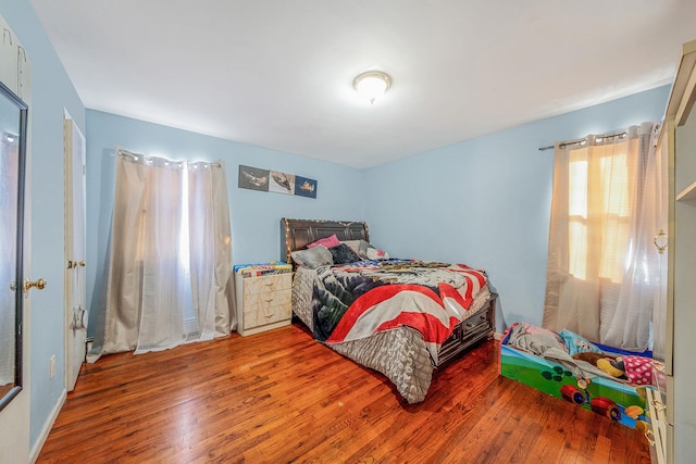 bedroom with hardwood / wood-style flooring