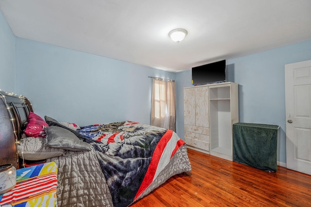 bedroom with hardwood / wood-style floors