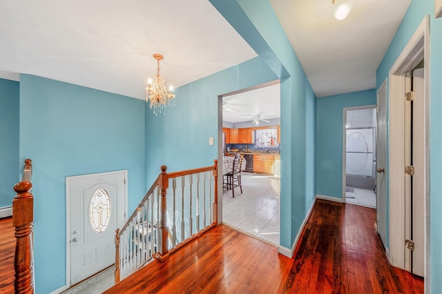 entryway featuring hardwood / wood-style flooring and a chandelier