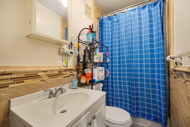 bathroom featuring vanity, toilet, and a shower with shower curtain