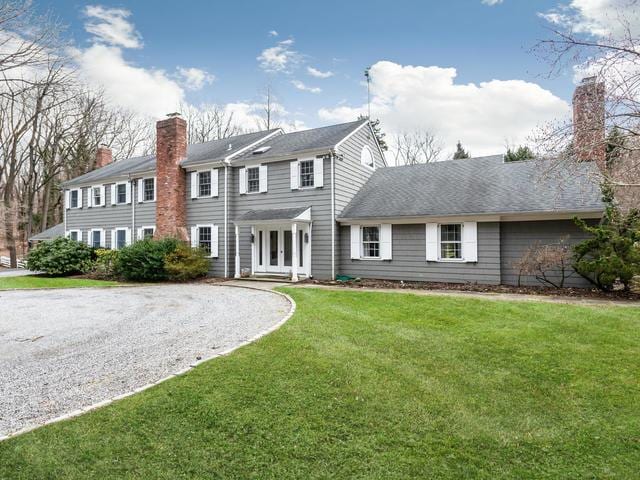 view of front of home with a front lawn and french doors