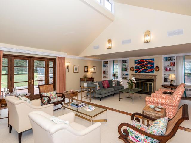 living room featuring built in shelves, high vaulted ceiling, and french doors