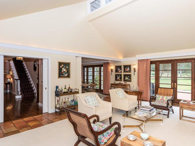 living room featuring french doors and high vaulted ceiling