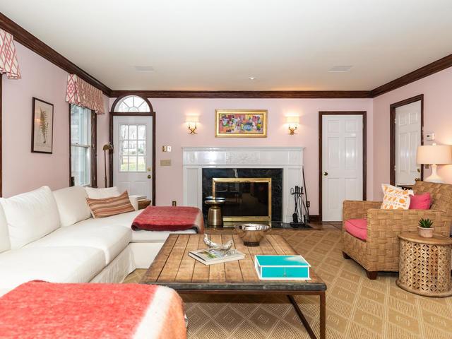 living room with a premium fireplace and crown molding