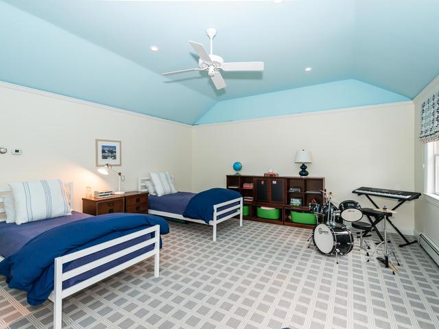 carpeted bedroom featuring lofted ceiling and ceiling fan