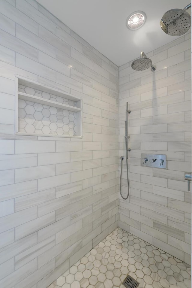 bathroom with a tile shower