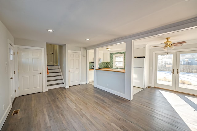 kitchen with a wealth of natural light, butcher block counters, sink, decorative backsplash, and white fridge