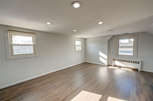 bonus room featuring radiator, vaulted ceiling, and hardwood / wood-style floors