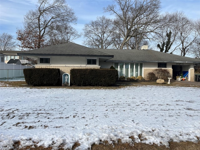 view of snow covered rear of property