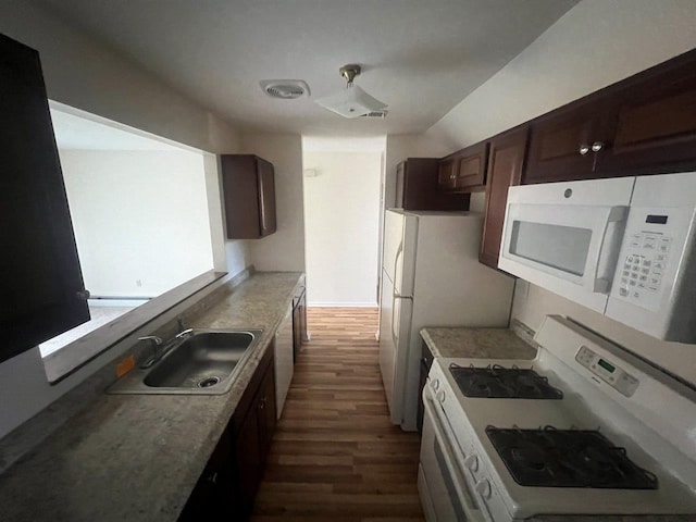 kitchen featuring dark wood-type flooring, white appliances, sink, and dark brown cabinets