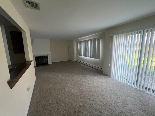 unfurnished living room with a baseboard radiator and carpet flooring