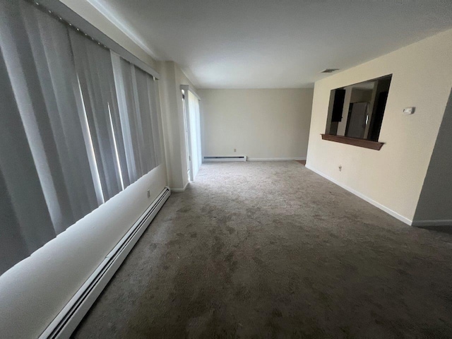 carpeted empty room featuring baseboard heating