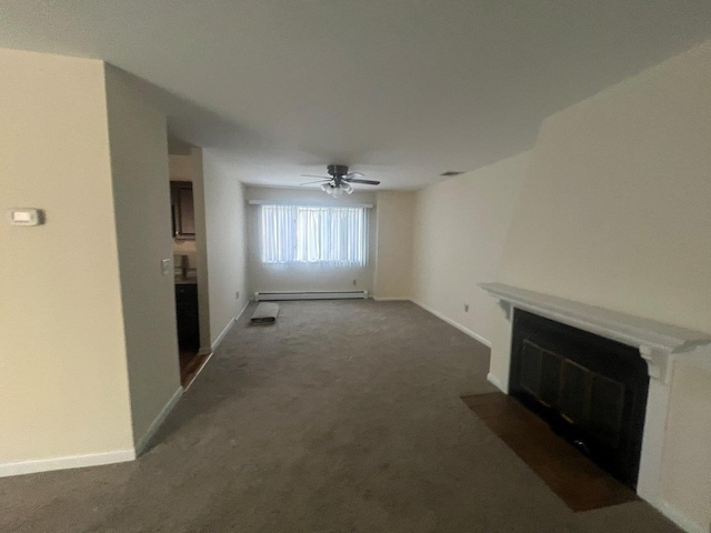 unfurnished living room featuring dark colored carpet, a baseboard radiator, and ceiling fan